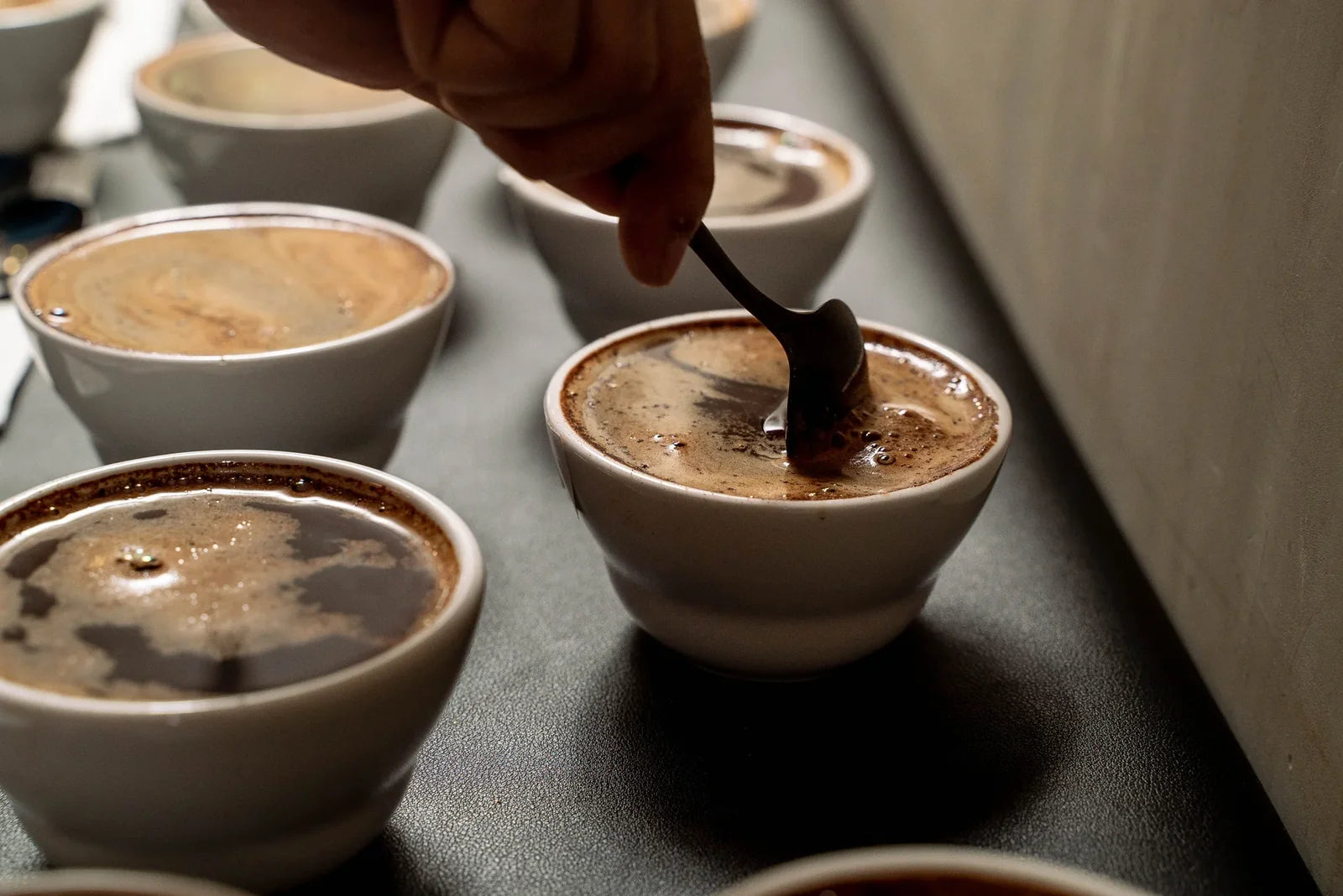 Coffee cupping session used to evaluate a wholesale coffee supplier's beans