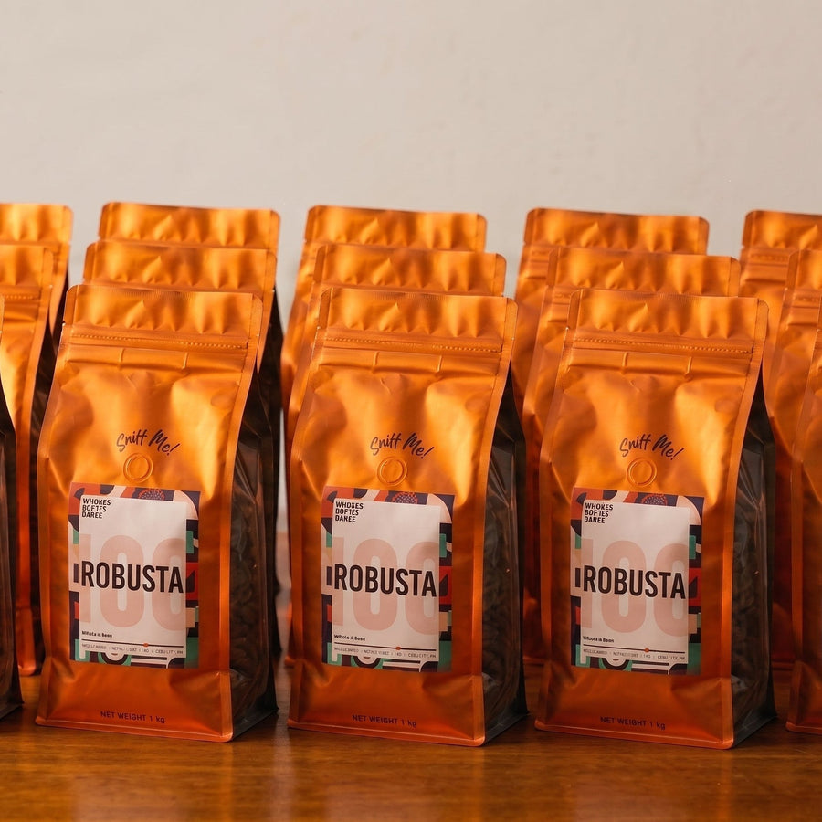 Row of sealed orange coffee bags from a Philippine wholesale coffee supplier